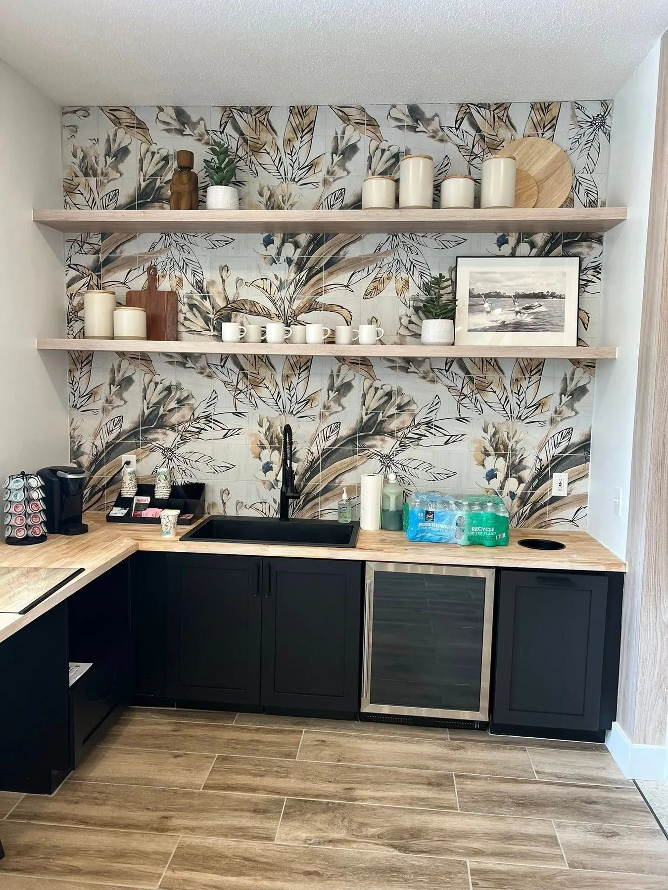 Built in beverage bar with floating shelves and dark base cabinets
