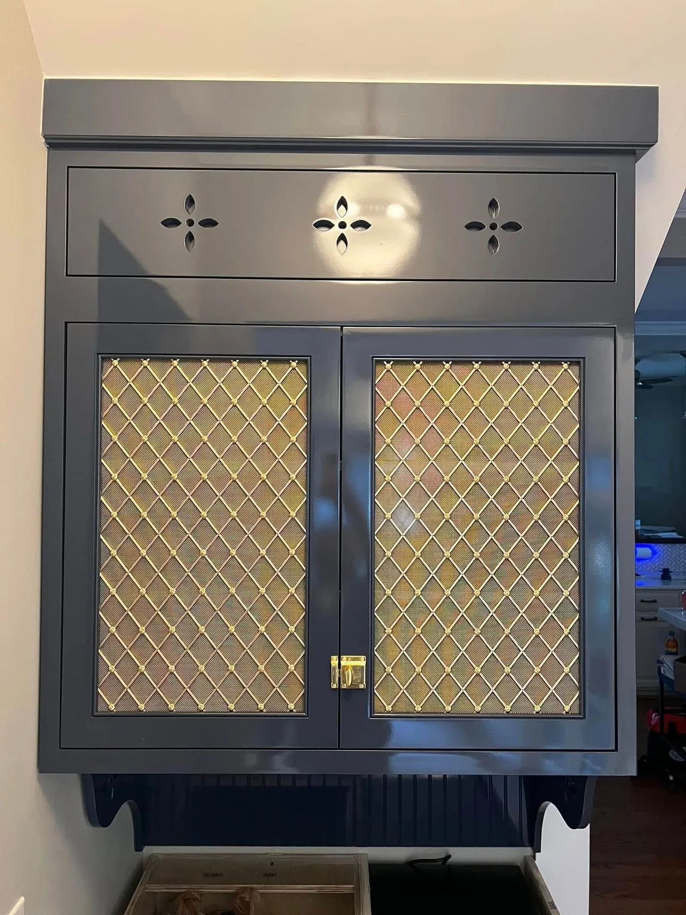 Custom cabinet doors with brass mesh inserts and a painted finish