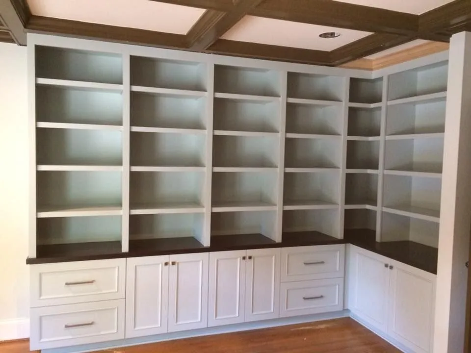 Custom white built in shelving and base cabinets in a living room