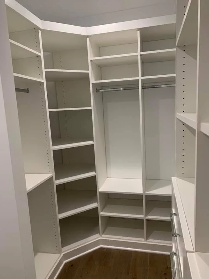 Custom white walk in closet shelving and hanging systems built by CTS Custom Cabinets