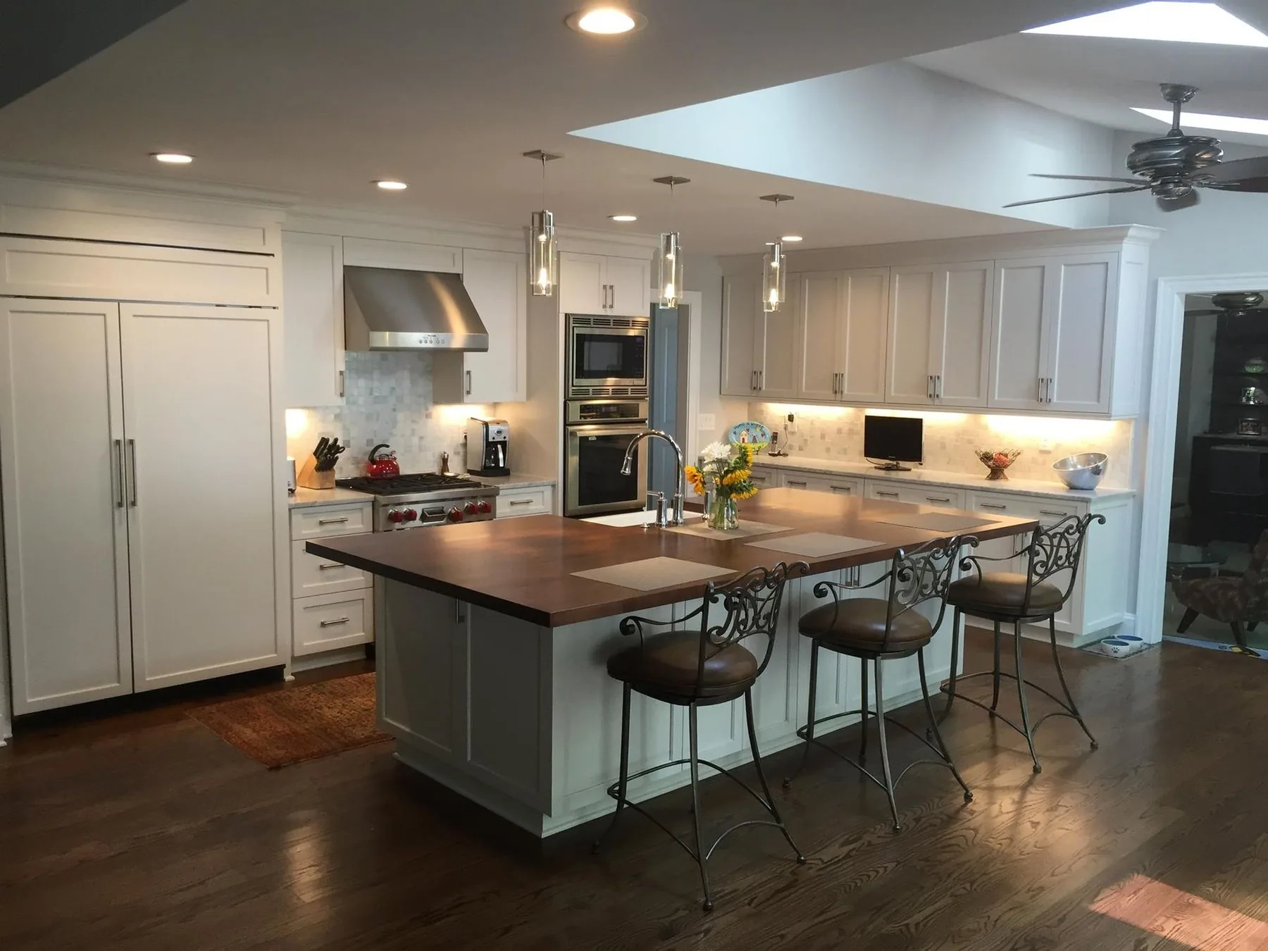 Custom kitchen by CTS Custom Cabinets with a walnut topped island and painted perimeter cabinetry