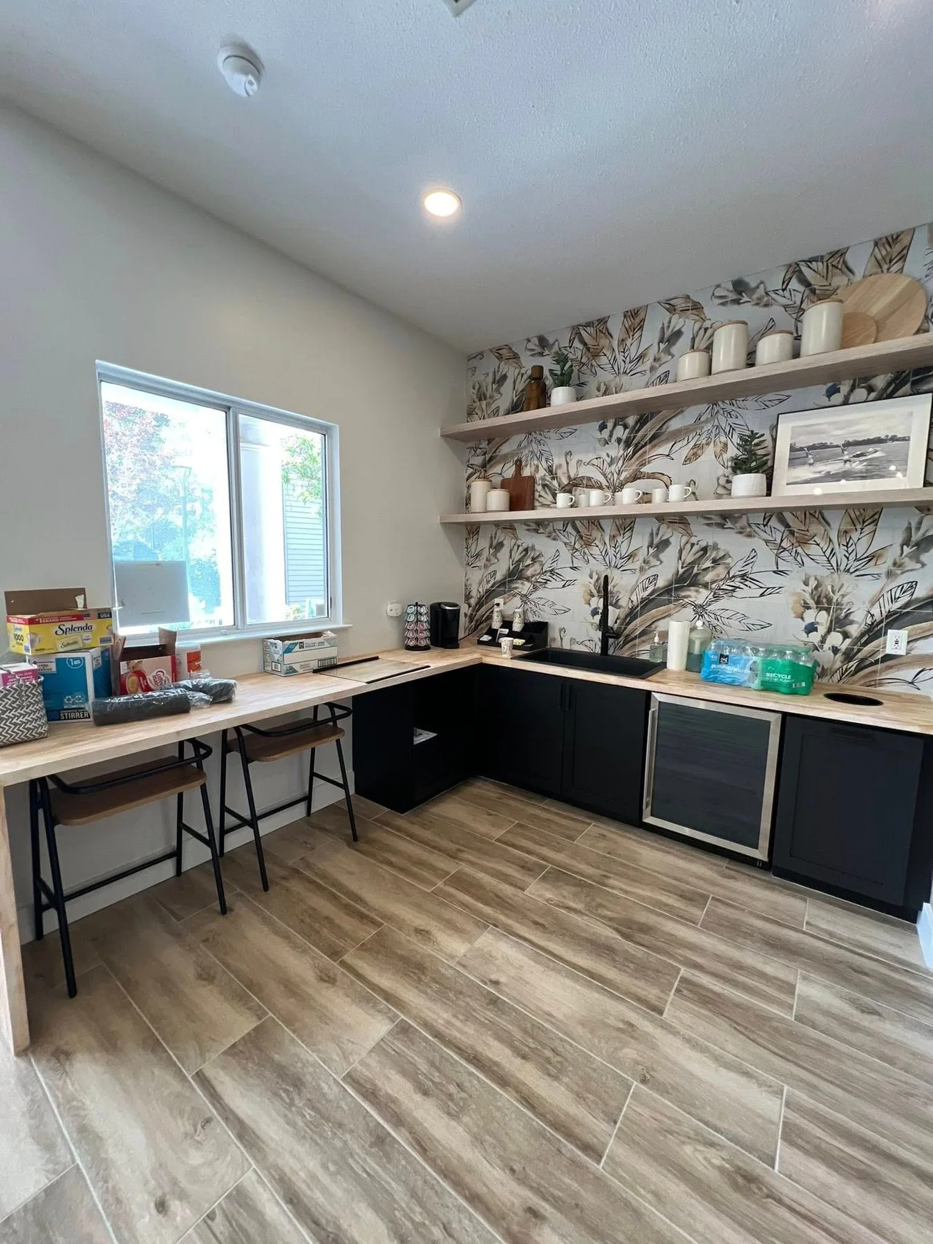Custom home office with a built in desk and wall of cabinetry